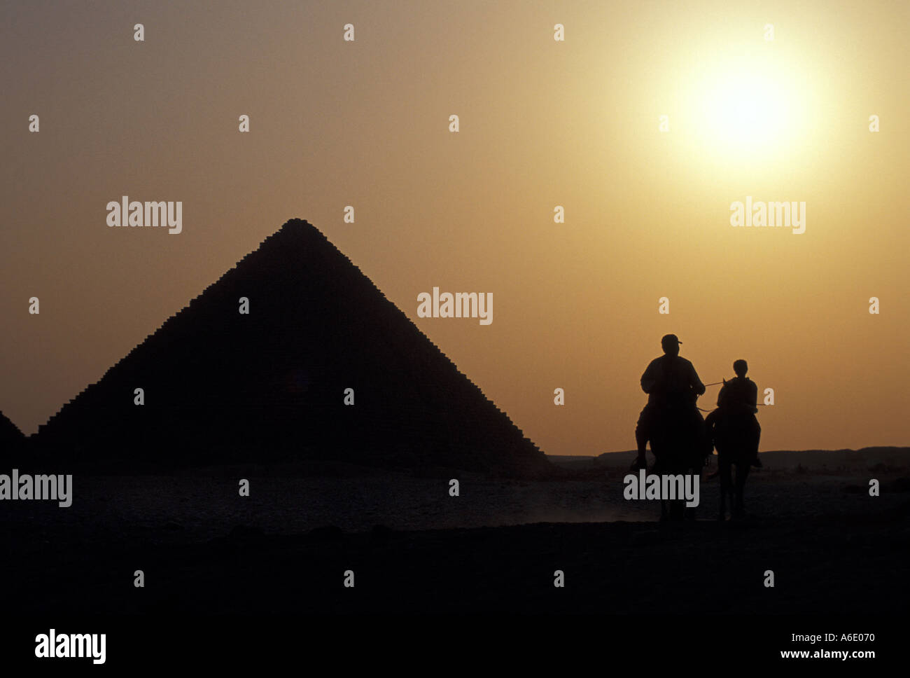 Father and Son Taking a Horse Ride near Great Pyramids of Giza at Sunset (Egypt) Stock Photo