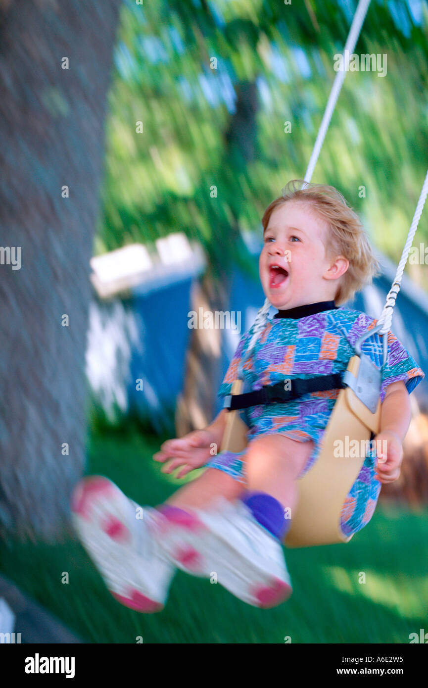 3 Year Old Boy Yelling With Excitement While Swinging On