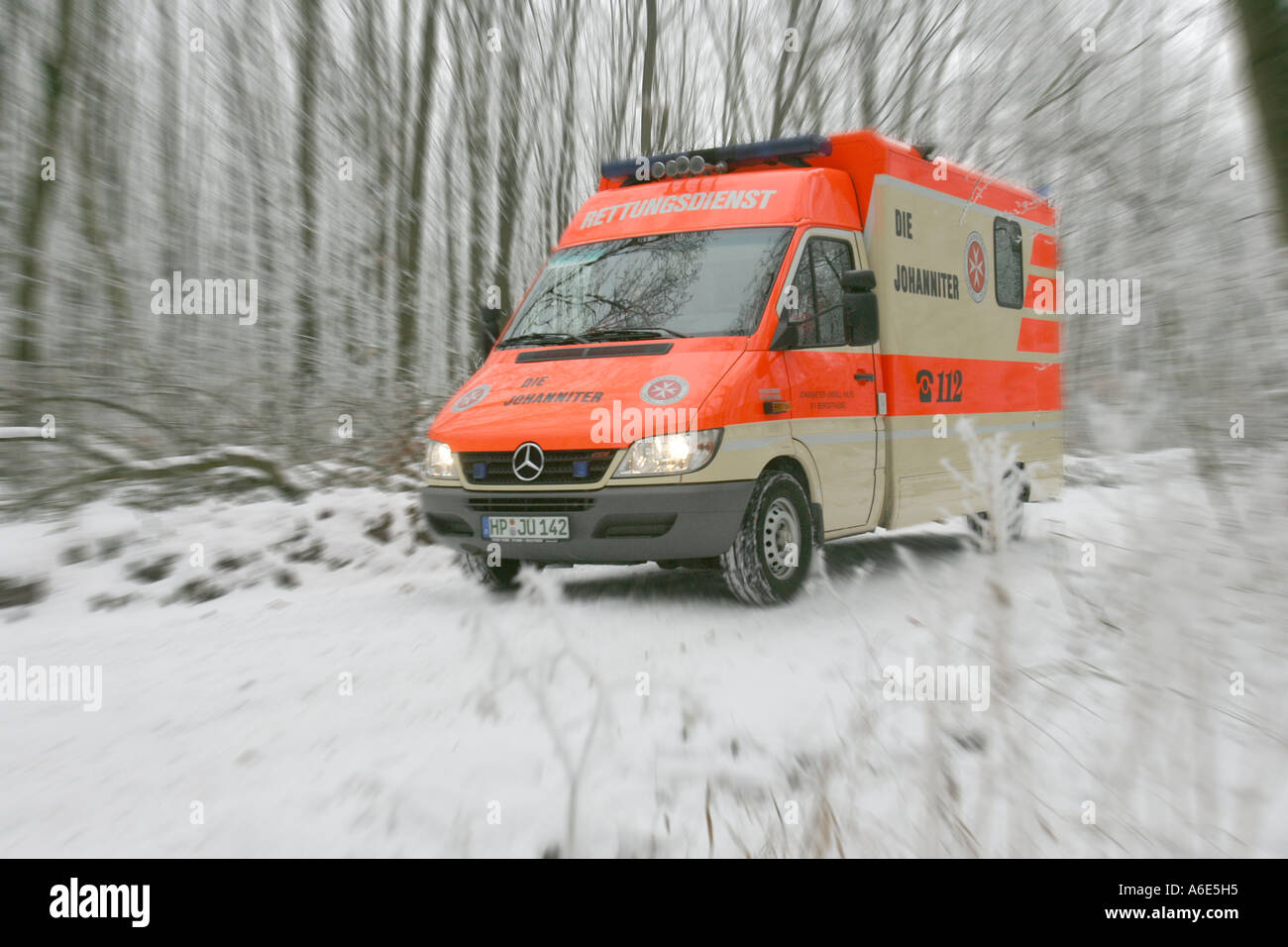 DEU, Federal Republic of Germany, Heidelberg, Johanniter ambulance vehicle drives on a Waldweg Stock Photo