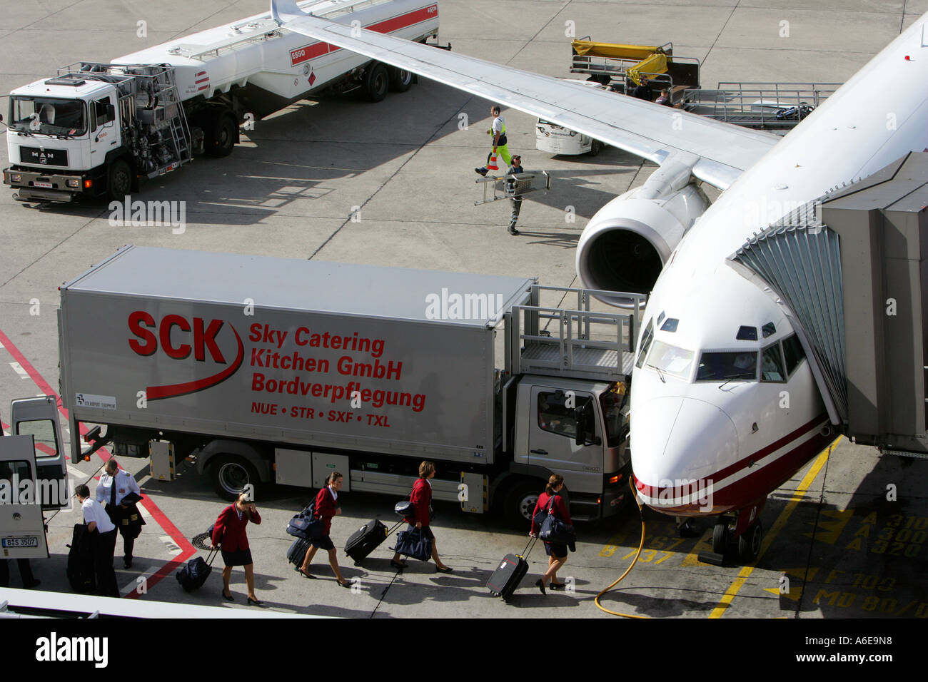 Catering vehicle serves an airplane while the crew gets on board at Tegel airport, Berlin Stock Photo