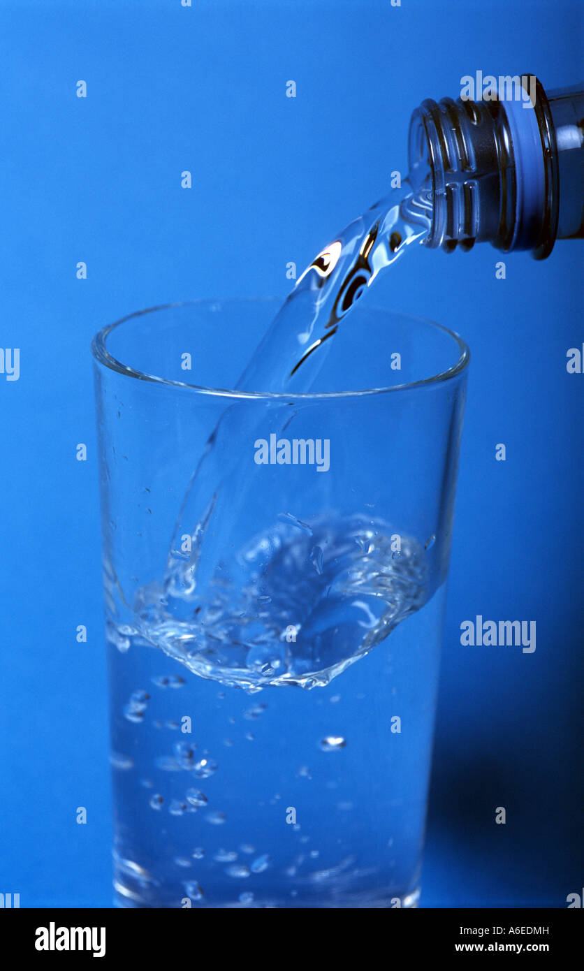 Bottled drinking water being poured into a glass Stock Photo Alamy