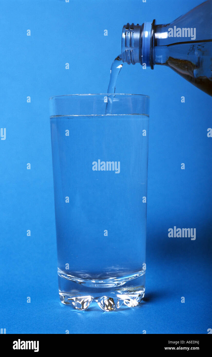 Bottled drinking water being poured into a glass Stock Photo Alamy