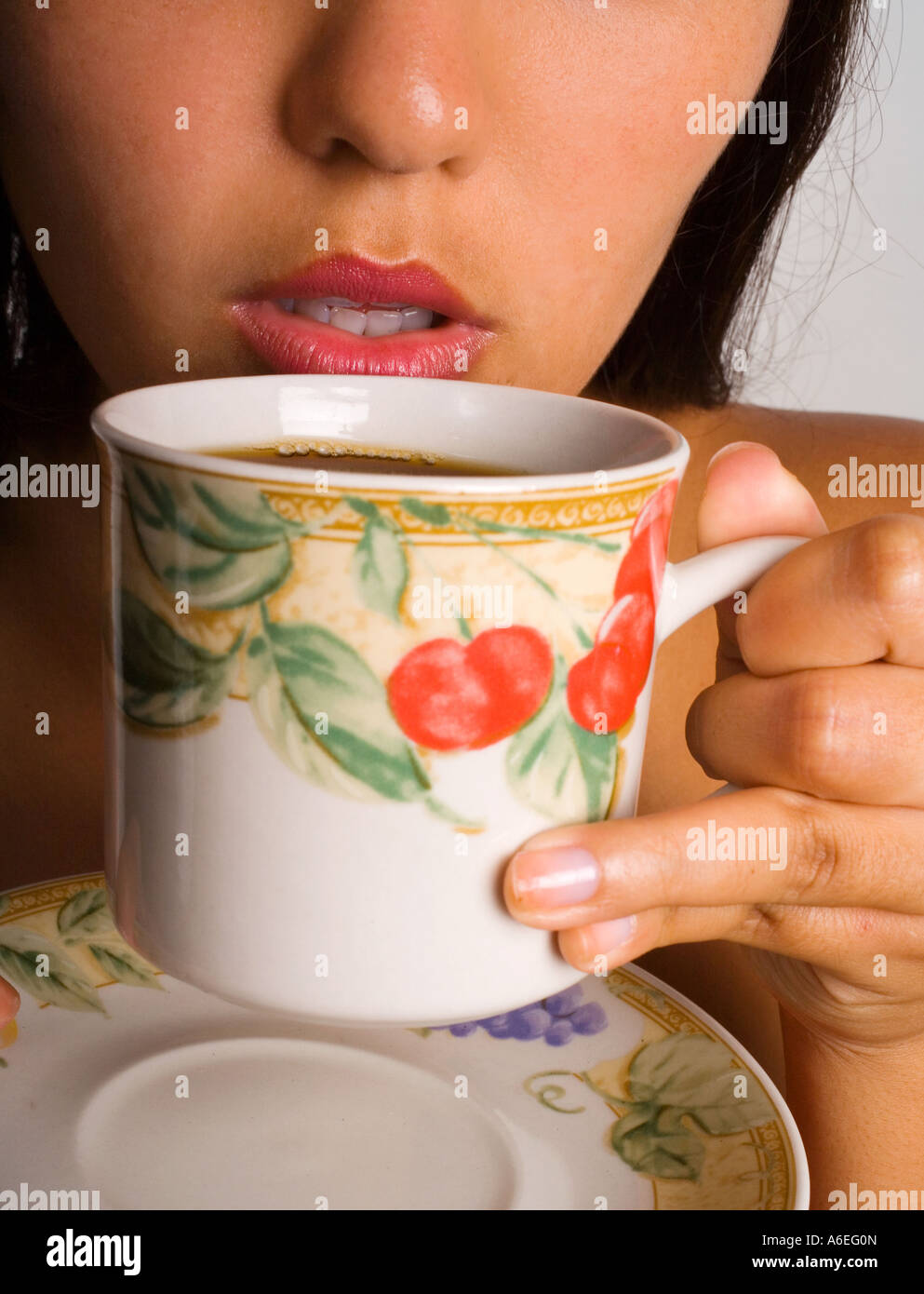 young woman about to have a taste of coffee Stock Photo Alamy