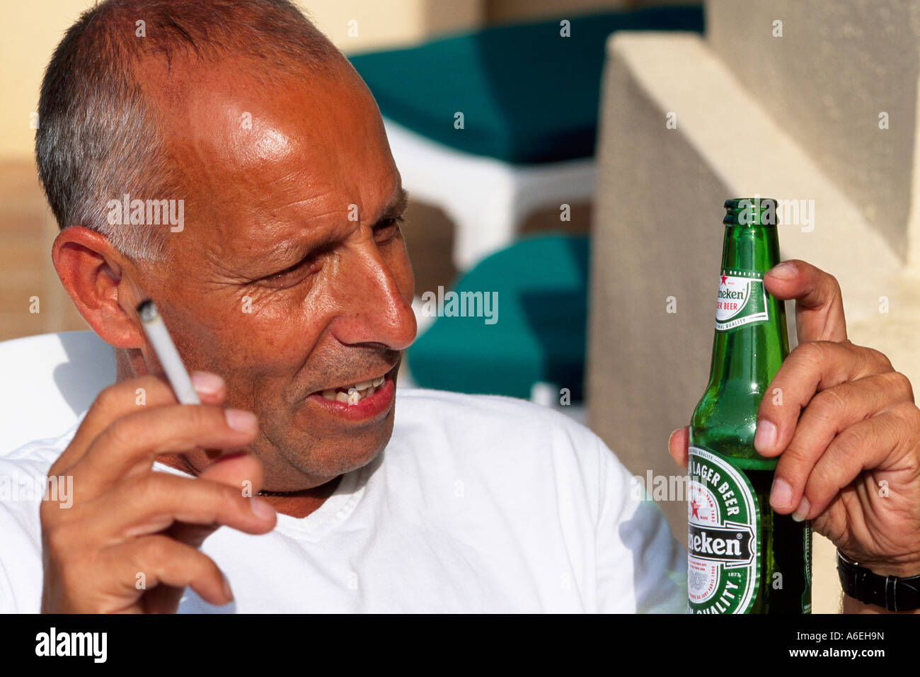Man Drinking Beer ad Smoking Cigarette Model Released Stock Photo