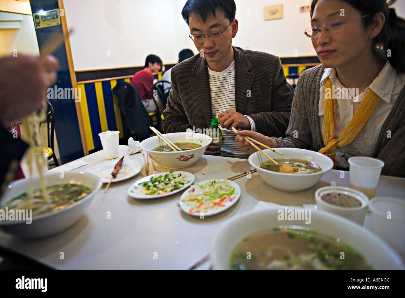 CHINA BEIJING Chinese couple enjoying noodle dishes served in fast food