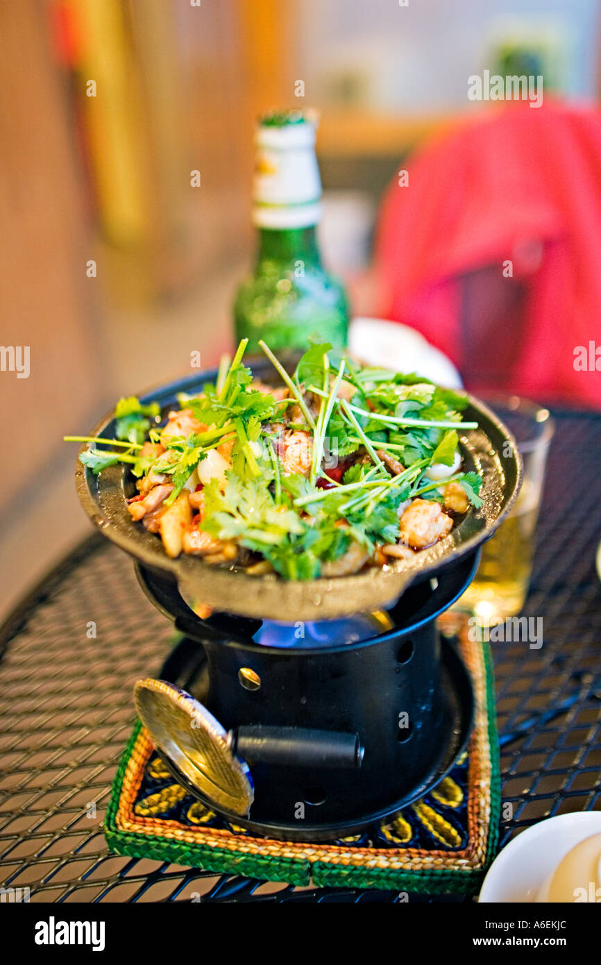CHINA BEIJING Charcoal grill with chicken peppers and cilantro cooking