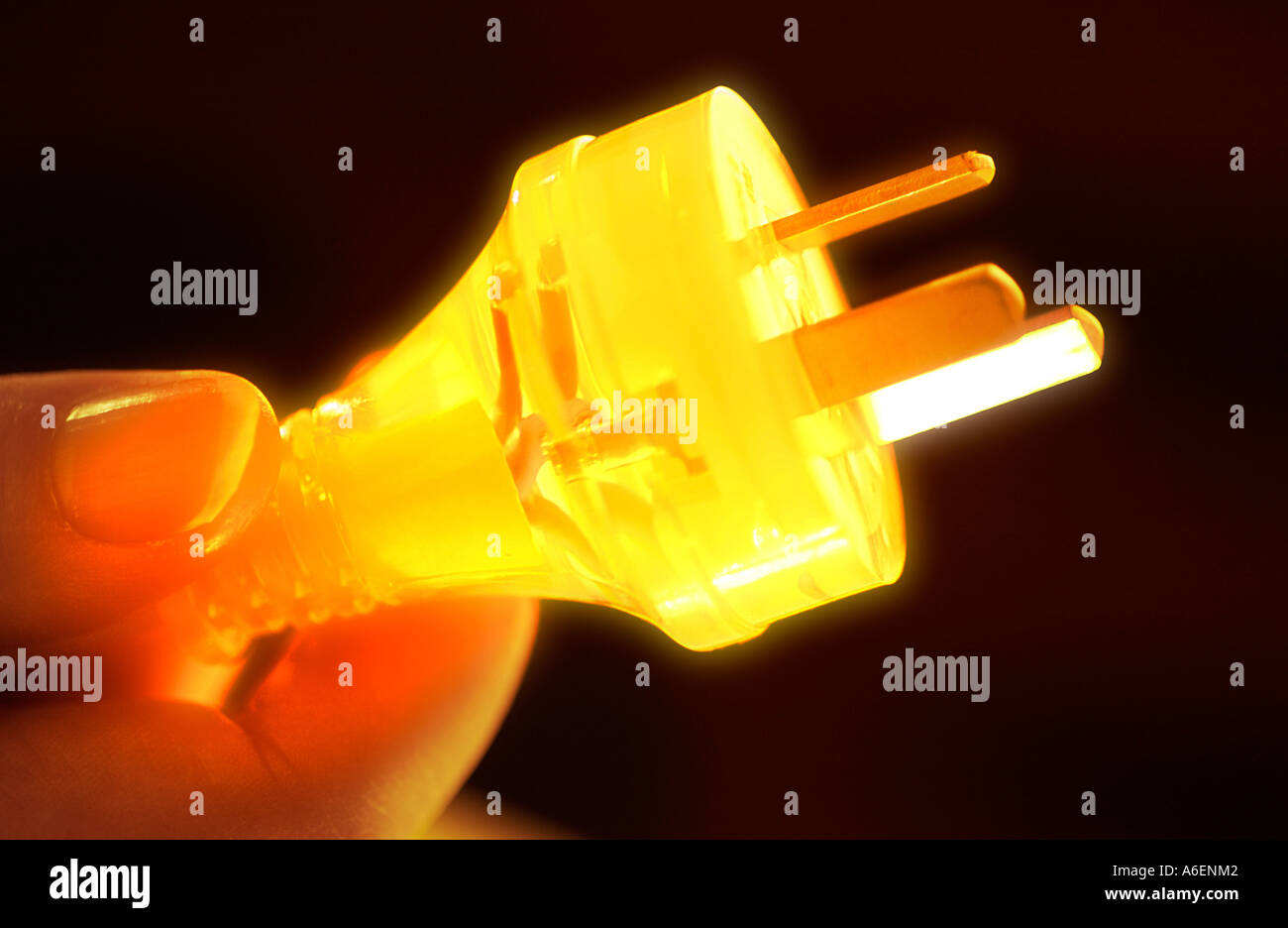 Glowing three pin plug New Zealand digitally enhanced image Stock Photo