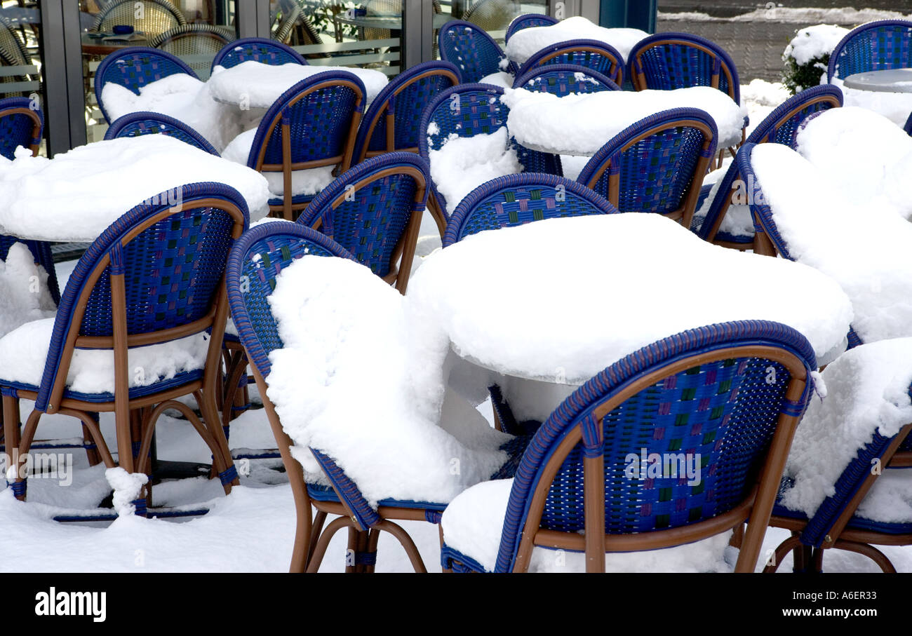 Snow covered outdoor seating area in German cafe Stock Photo