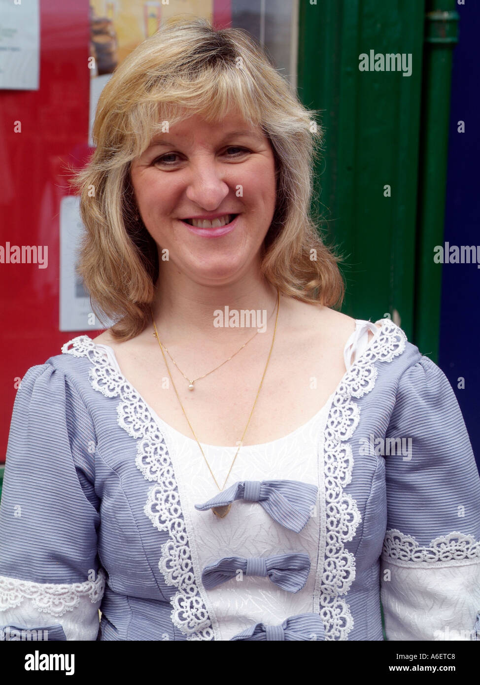 Portrait of a woman smiling wearing a traditional dress during a May day celebration in England Stock Photo