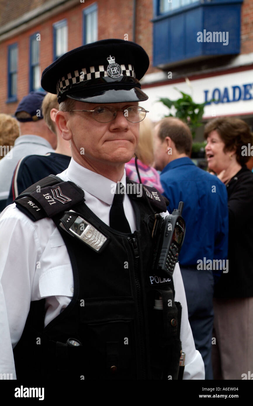 British Police Officer on duty wearing his ant-stab vest and cellphones  Stock Photo - Alamy