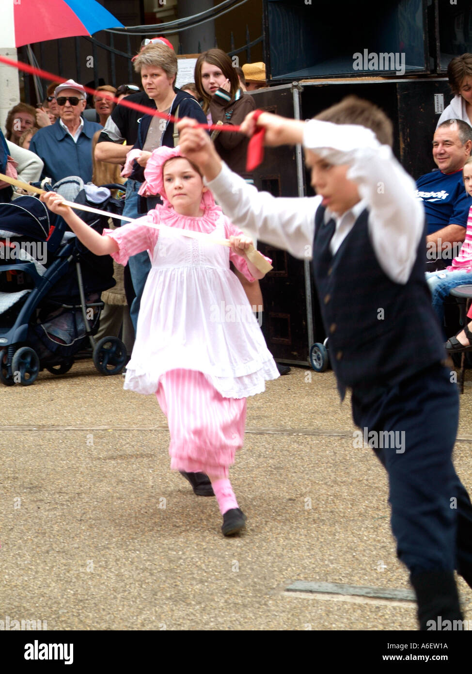 School children perform a Maypole dance routine dressed in traditional