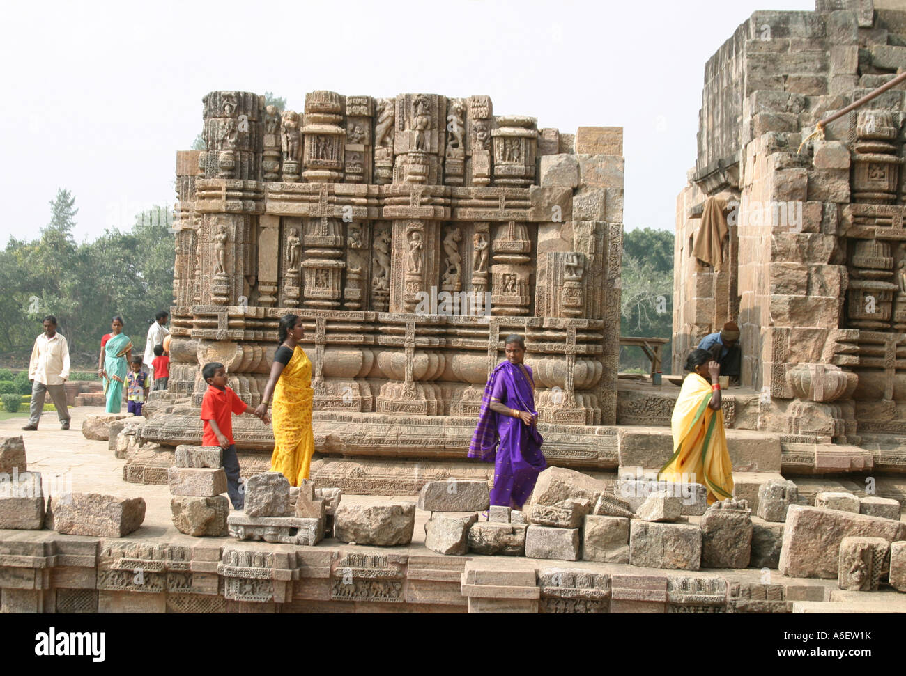 Tourists walking amongst the ruins of Konark Sun Temple  on the Bay of Bengal Orissa INDIA Stock Photo