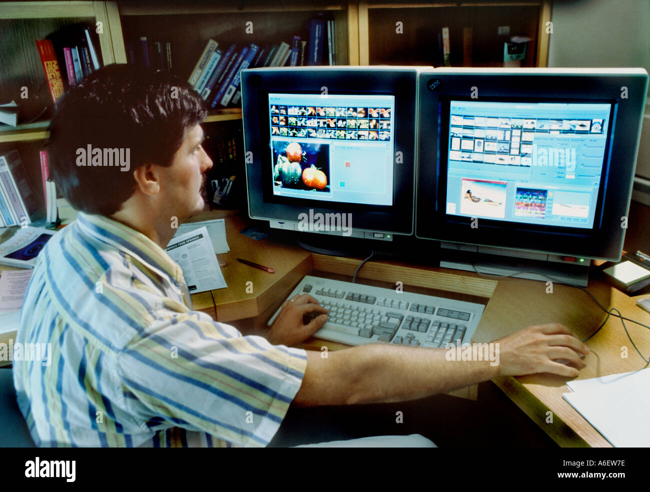 Basking Ridge, NJ US,  Research and Development  Laboratory Man Working on Computer Software Photo Images on Two Screens Office, people looking Stock Photo