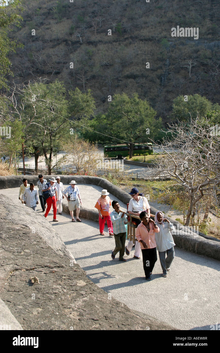 Tourists visiting the Ajanta Caves Complex being carried up the long run of steps to the caves.Maharashtra India Stock Photo