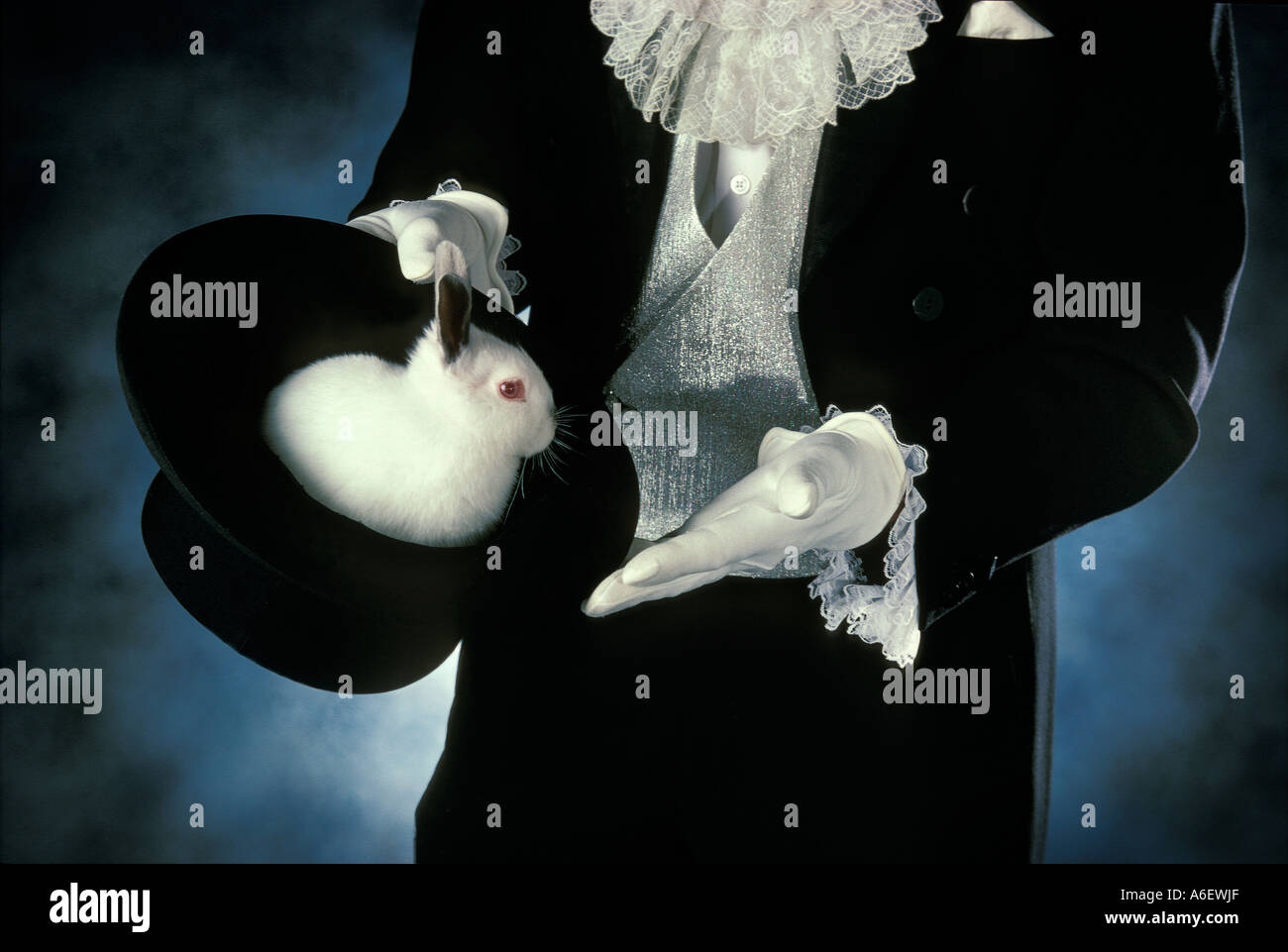 Magician with rabbit in top hat Stock Photo