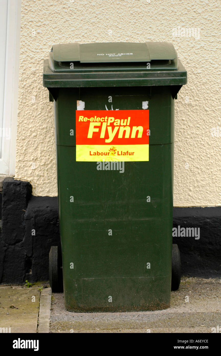 Welsh Labour election poster to re elect local MP Paul Flynn on a green wheelie bin outside house Newport Gwent South Wales UK Stock Photo