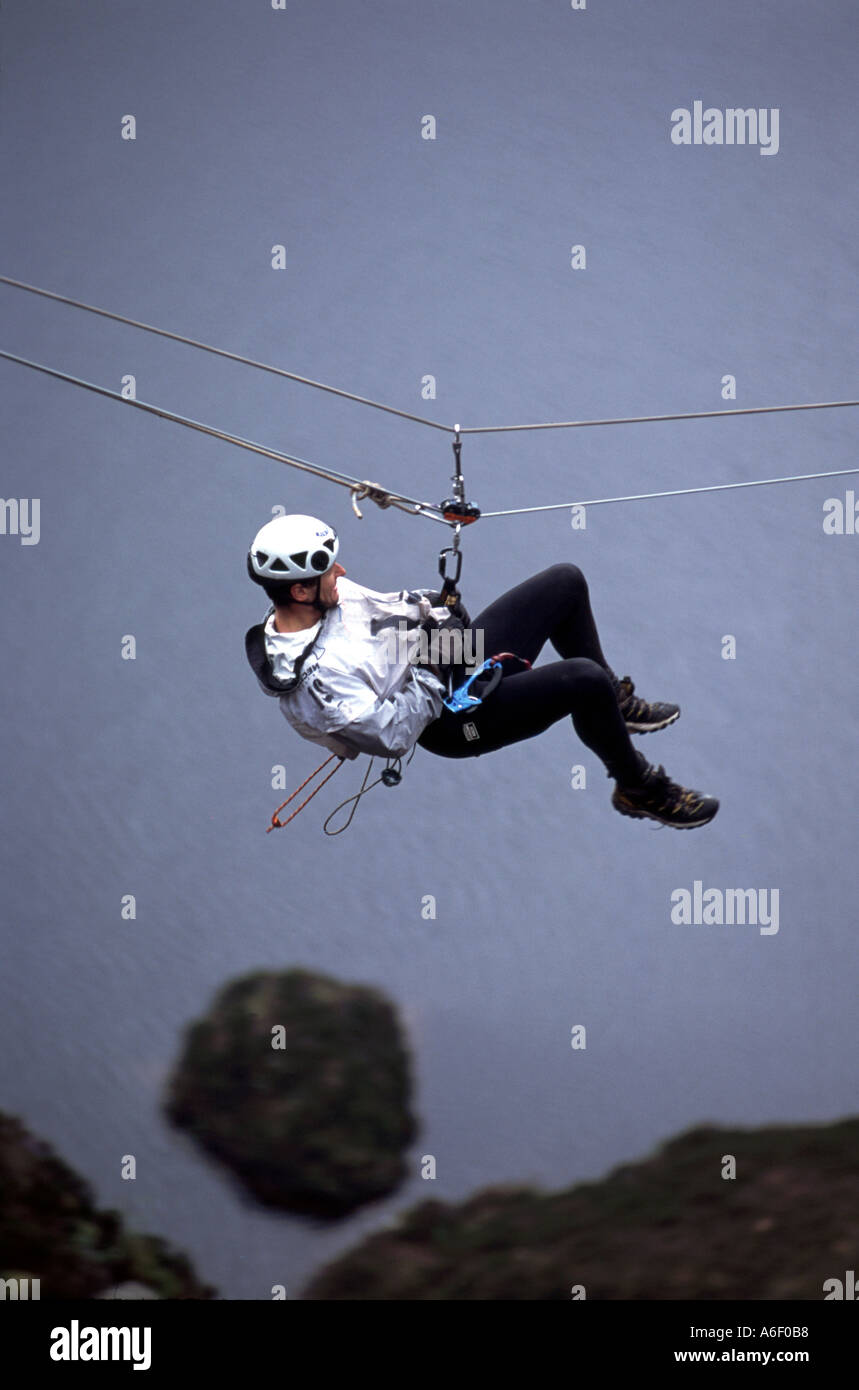 Adventure athlete on zip line descent Stock Photo Alamy