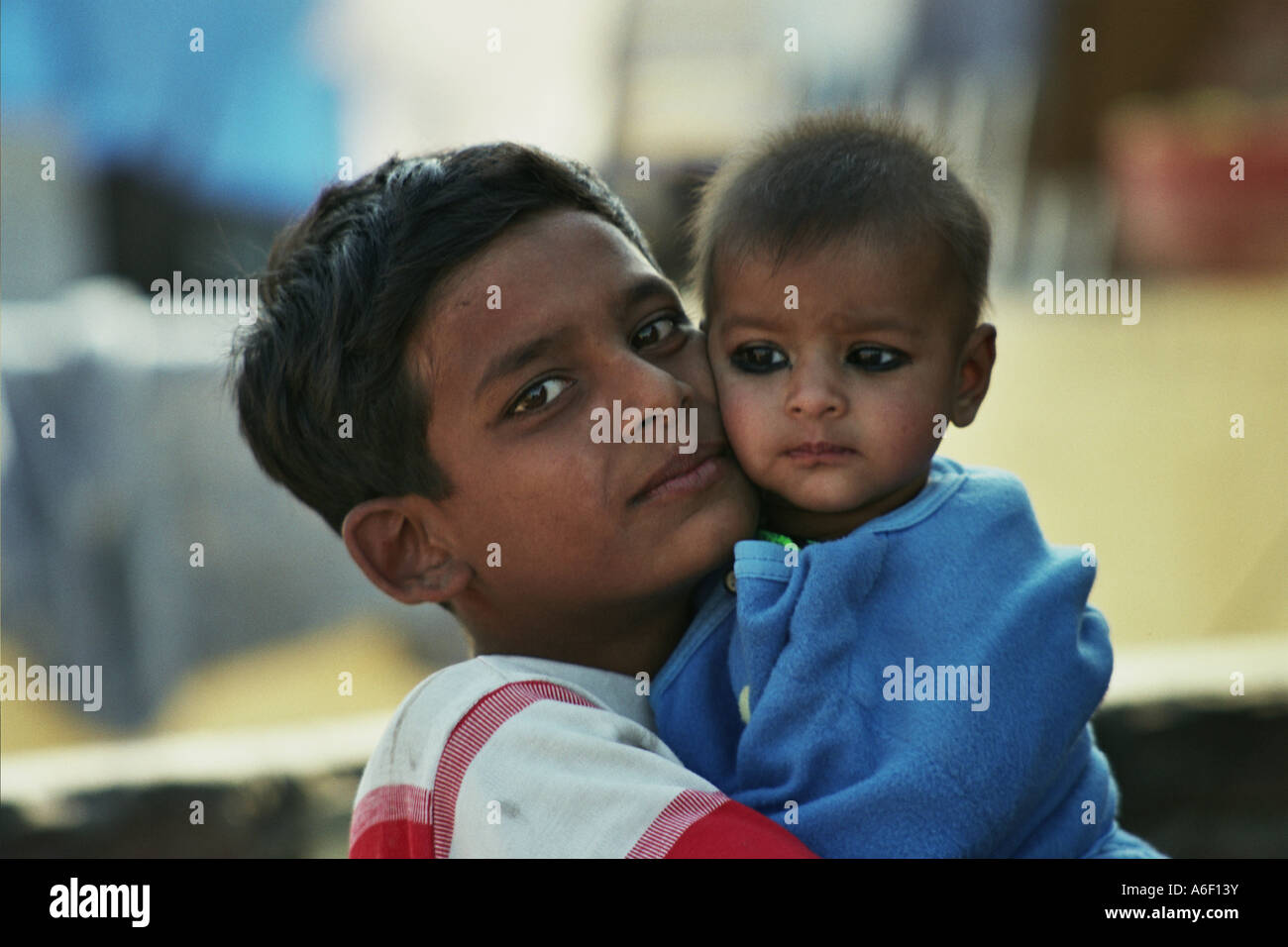Boy holding baby Stock Photo Alamy