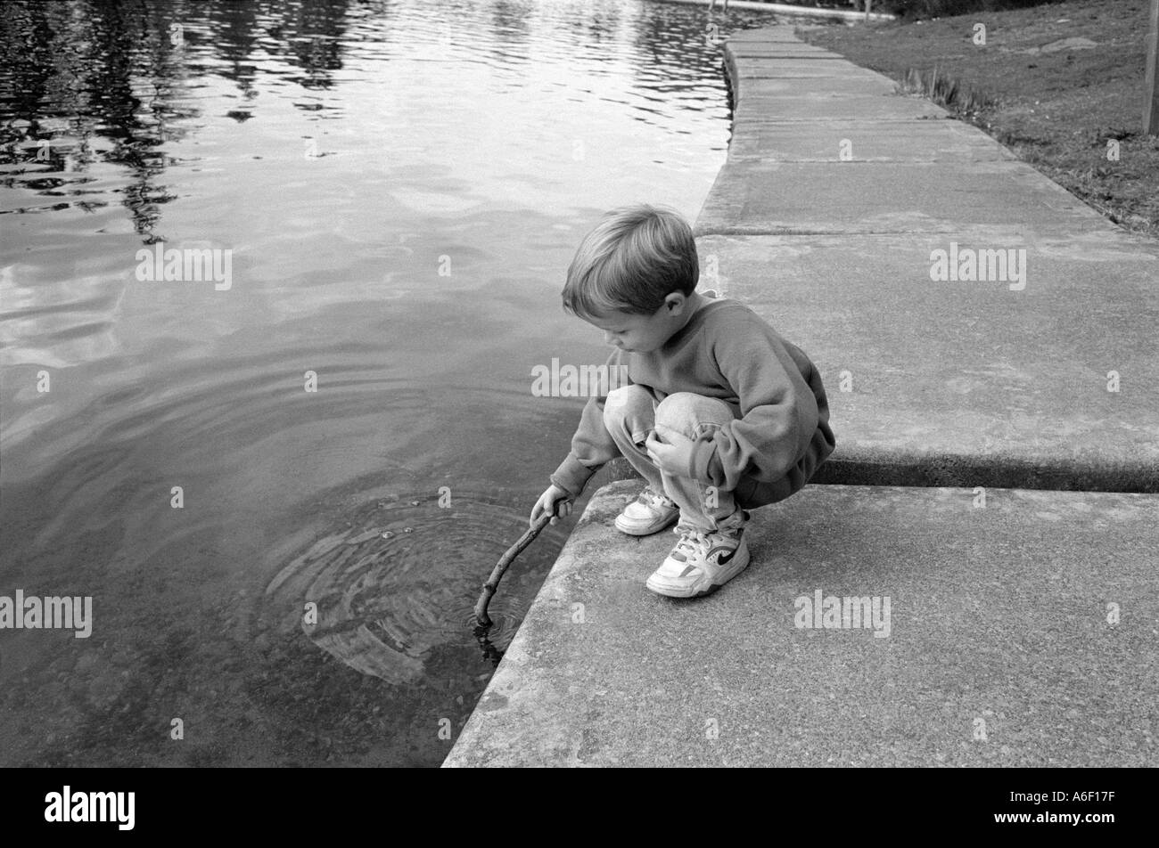 Boy playing in lake Black and White Stock Photos & Images - Alamy