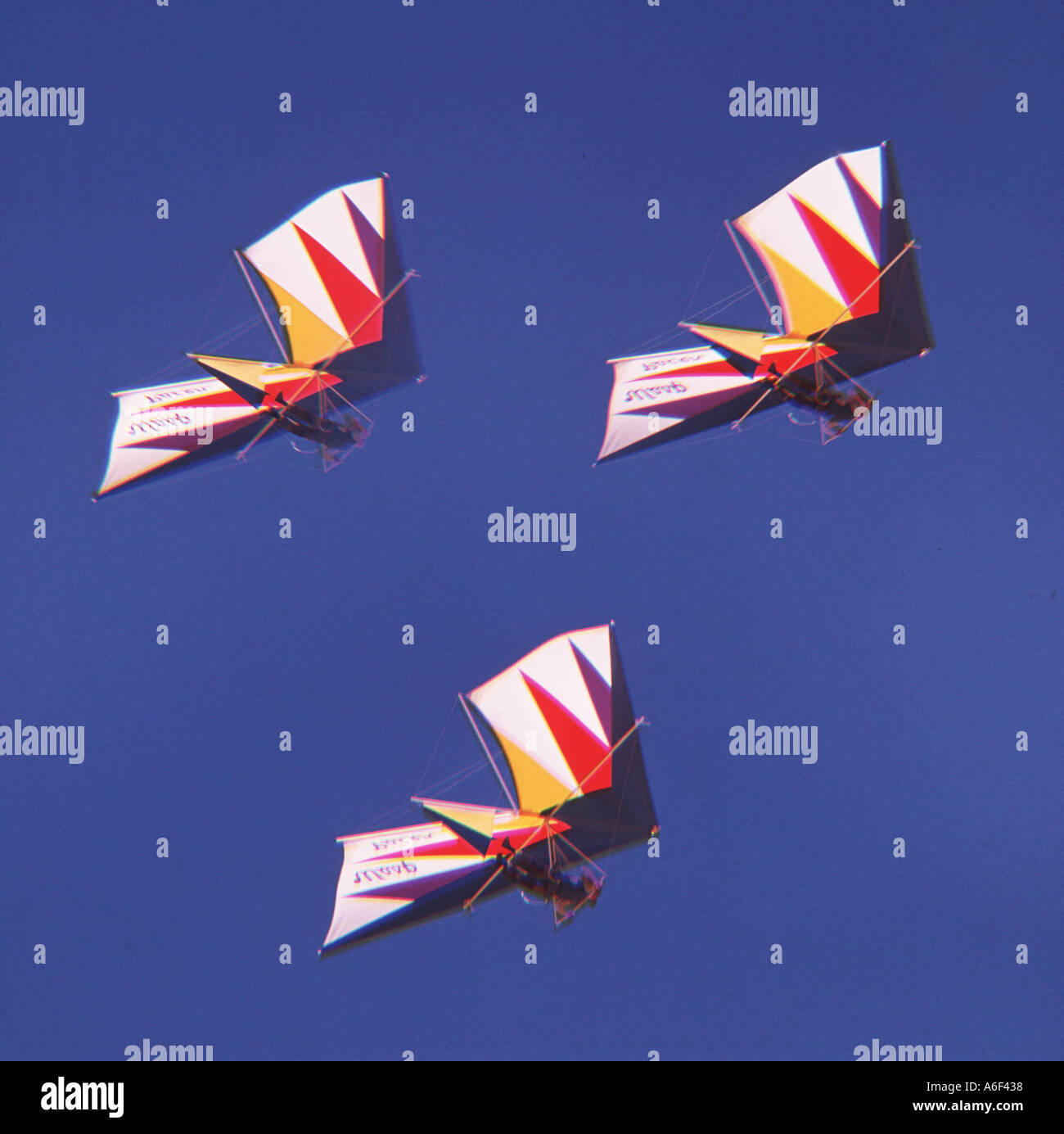 three hang gliders on Oregon coast in formation Stock Photo