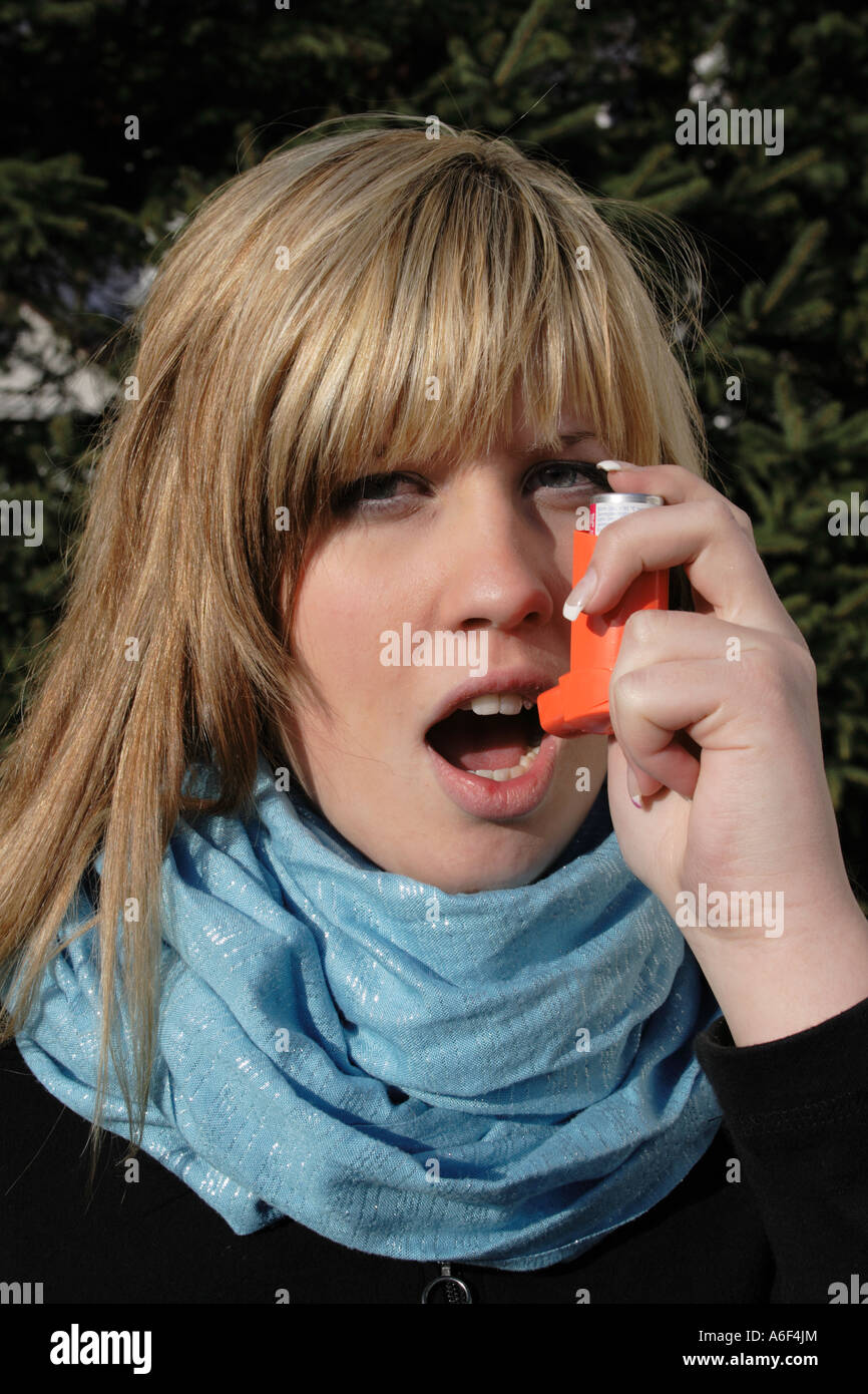 caucasian teenage  girl uses a bronchial dilator against symptoms of asthma. Photo by Willy Matheisl Stock Photo
