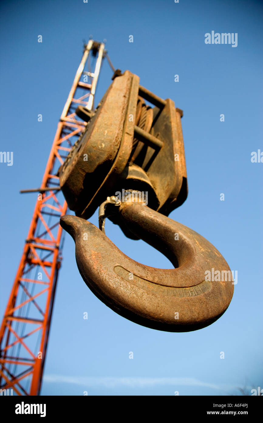 old rusty pulley hook hanging from cable boom, California Stock Photo