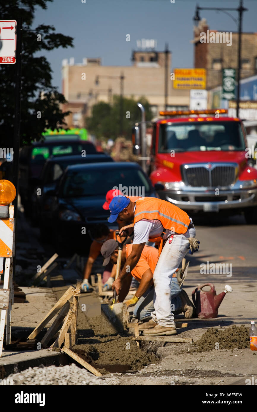 CHICAGO Illinois Construction workers smooth concrete curb street in