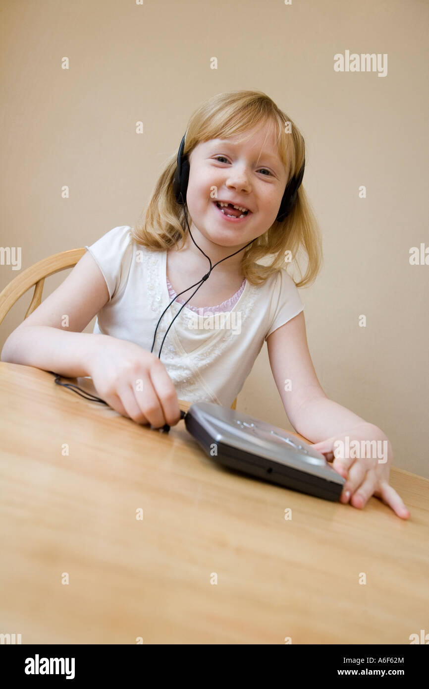 Young girl singing as she listens to music on her cd player Stock Photo