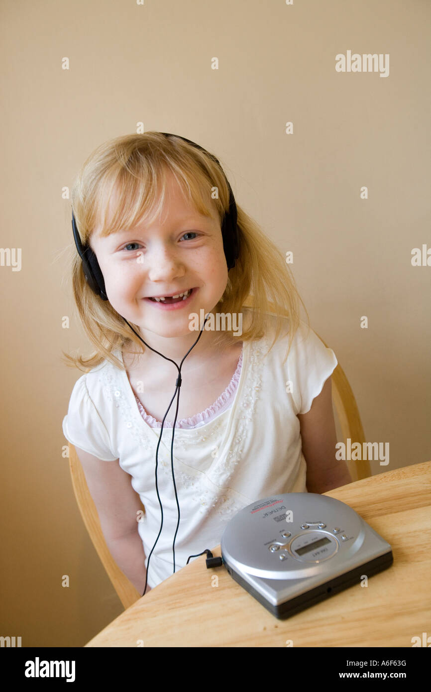 Young girl having fun as she listens to music on her cd player Stock Photo
