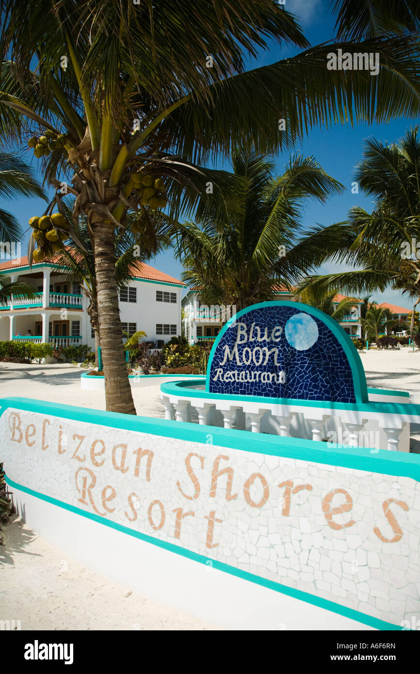 BELIZE Ambergris Caye Belizean Shores Resort sign and buildings palm trees and sandy beach Stock Photo