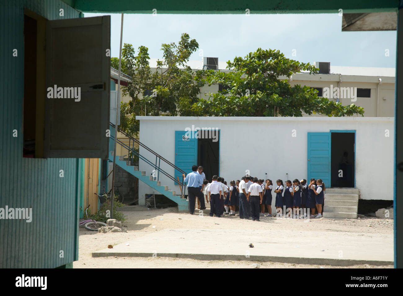 BELIZE San Pedro on Ambergris Caye Children wait in line after recess outside Catholic school Stock Photo