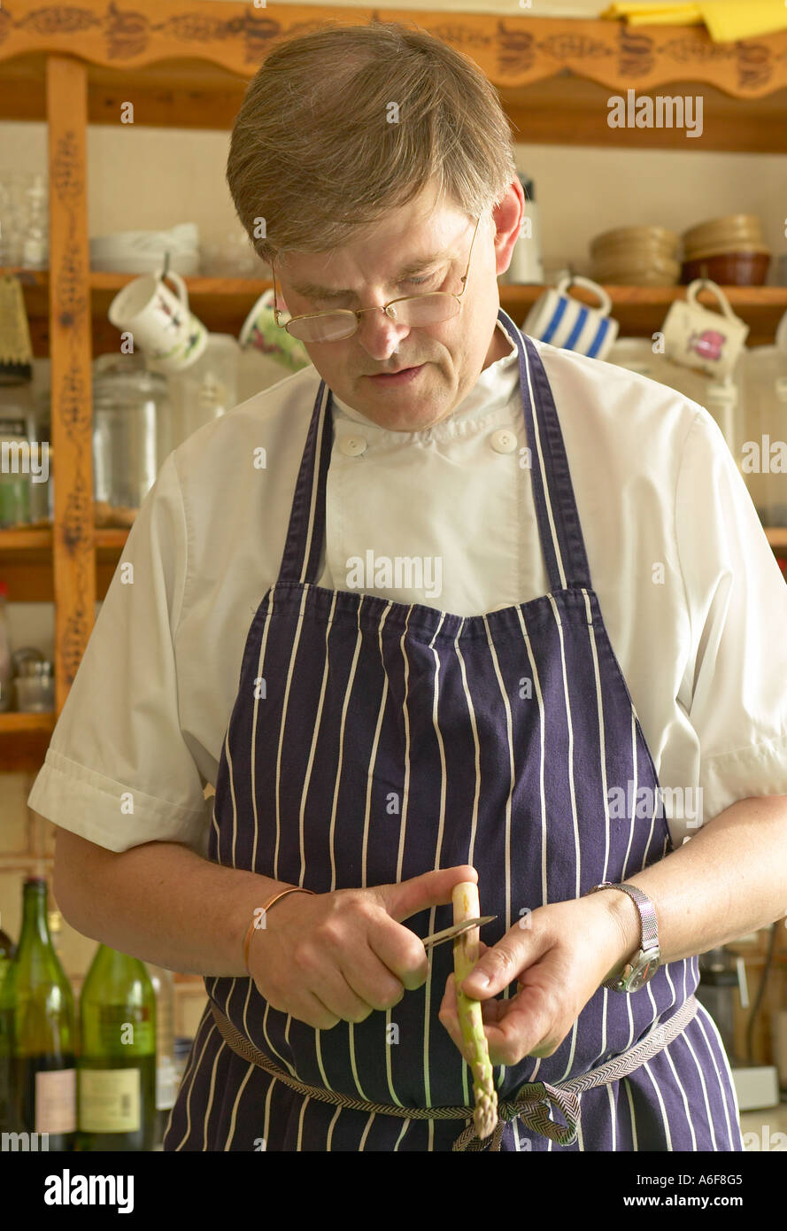 chef preparing food in country hotel kitchen Stock Photo