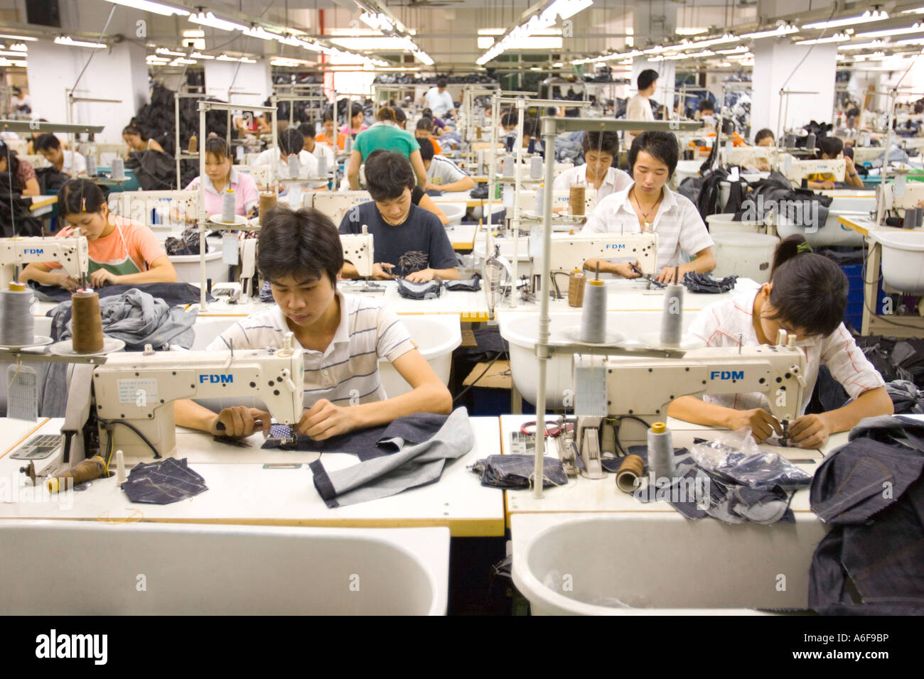 SHENZHEN GUANGDONG PROVINCE CHINA Workers sewing Mango jeans in garment
