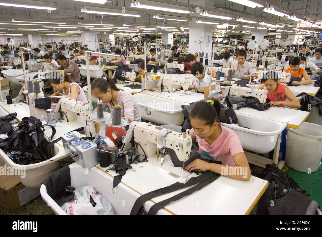 SHENZHEN GUANGDONG PROVINCE CHINA Workers sewing Mango jeans in garment  factory in city of Shenzhen Stock Photo - Alamy