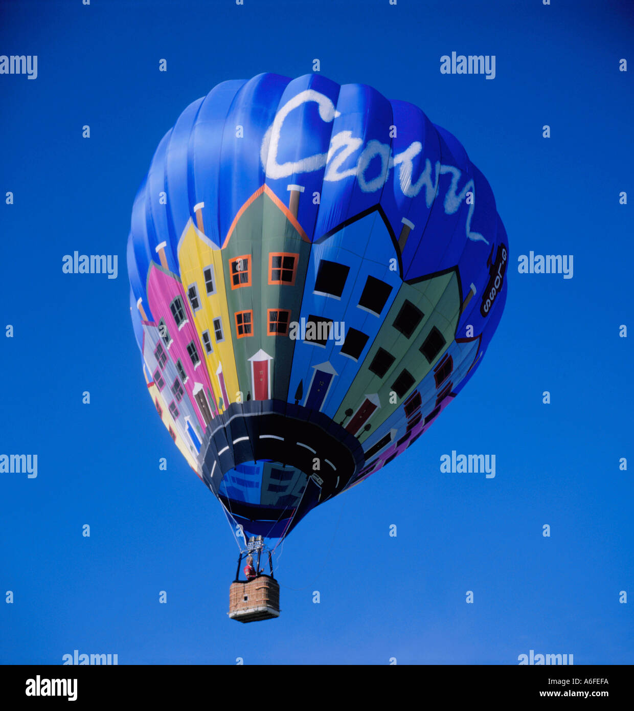 Brightly coloured hot air balloon (sponsored by Crown Paints) in flight