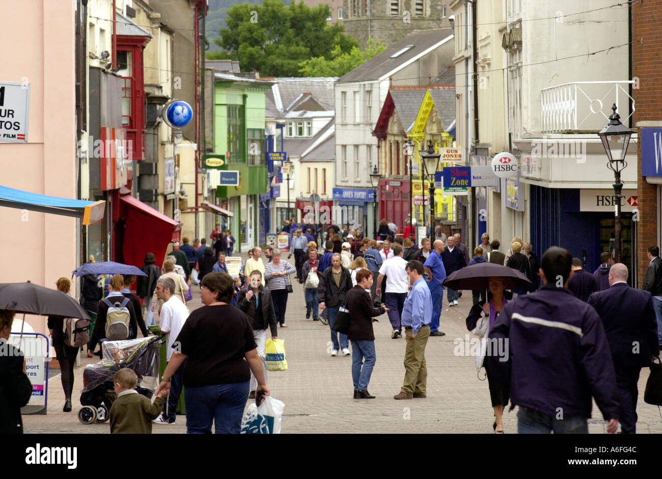 General view of shopping street with people shopping at Merthyr Tydfil in the South Wales Valleys UK Stock Photo