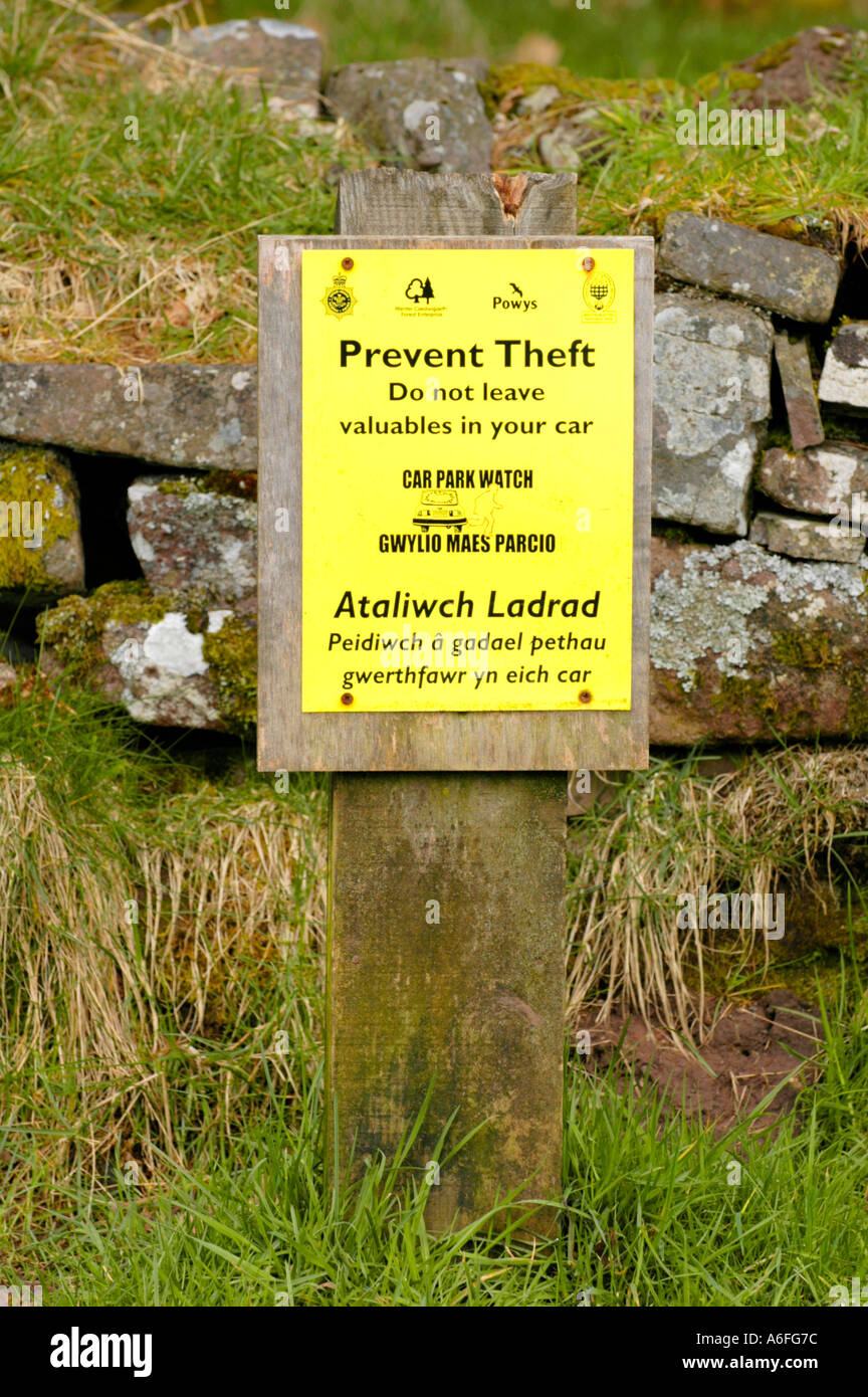 Bilingual Welsh English language PREVENT THEFT sign in a car park in the Brecon Beacons National Park Powys South Wales UK Stock Photo