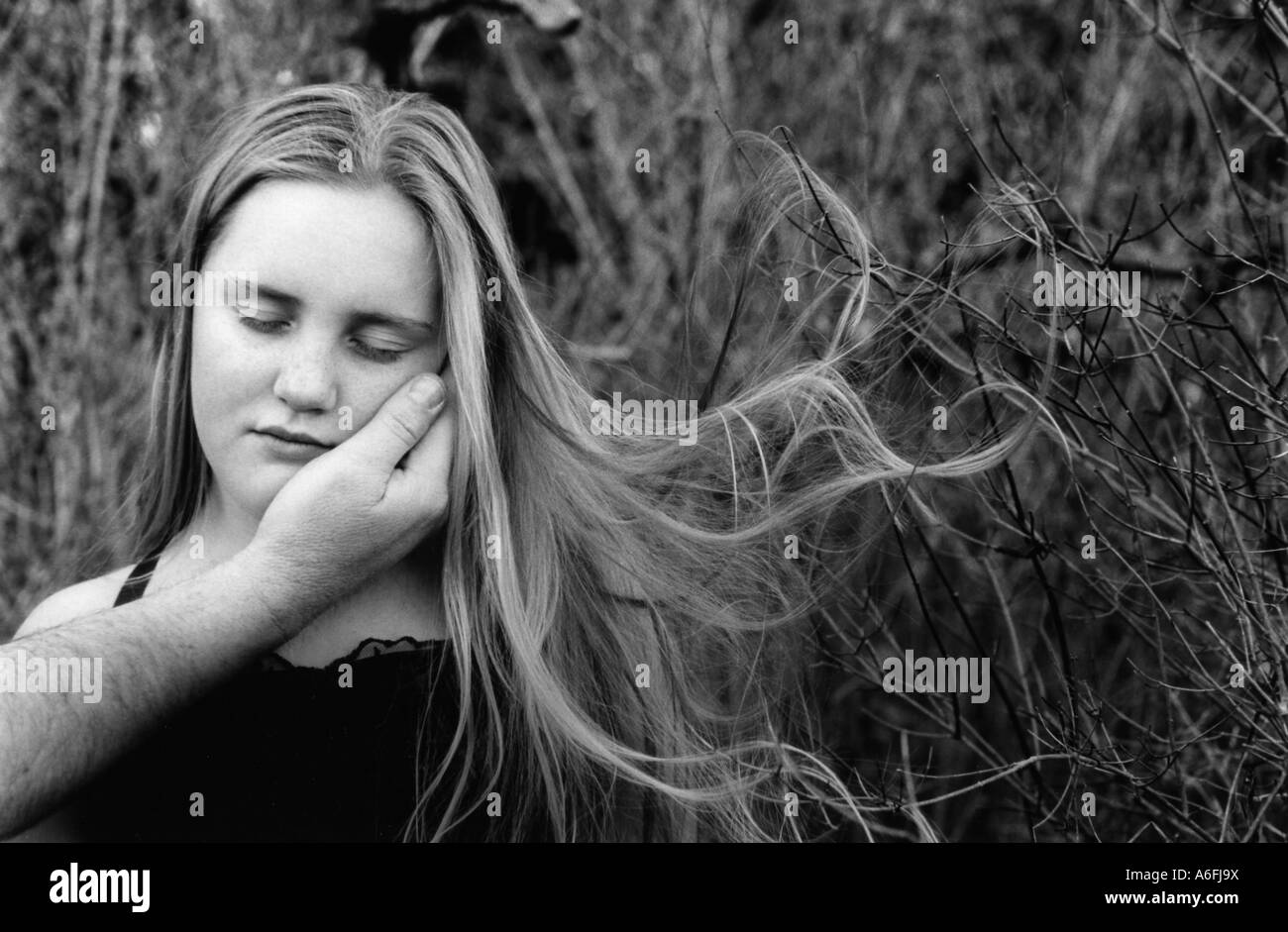 Hand holding girl face Stock Photo Alamy