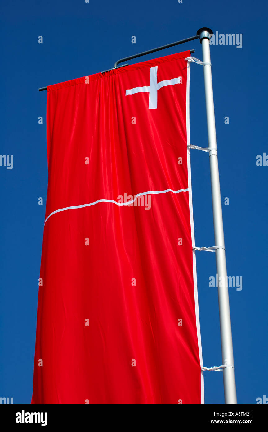 Banner of Swiss canton Schwyz against a clear blue sky Stock Photo