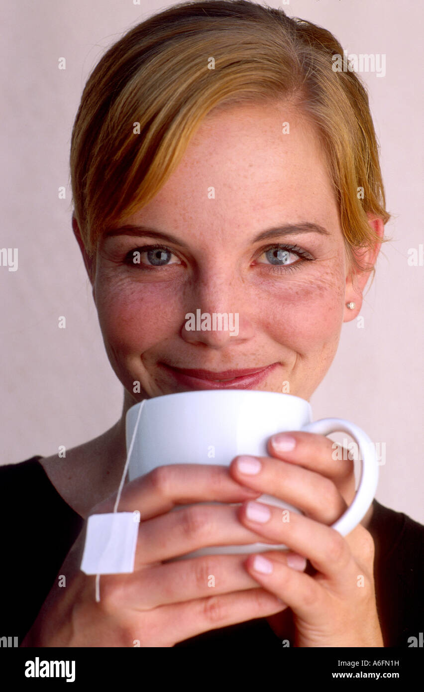 Woman enjoying a mug of hot tea Stock Photo