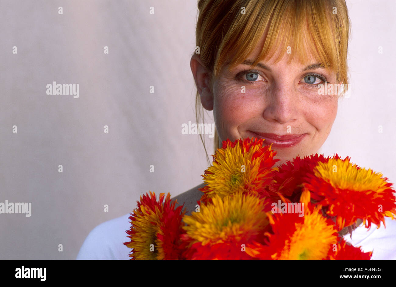 Woman holding up bright bouquet of flowers Stock Photo
