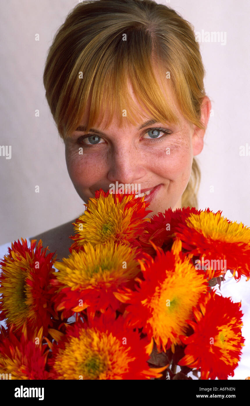 Woman holding up bright bouquet of flowers Stock Photo