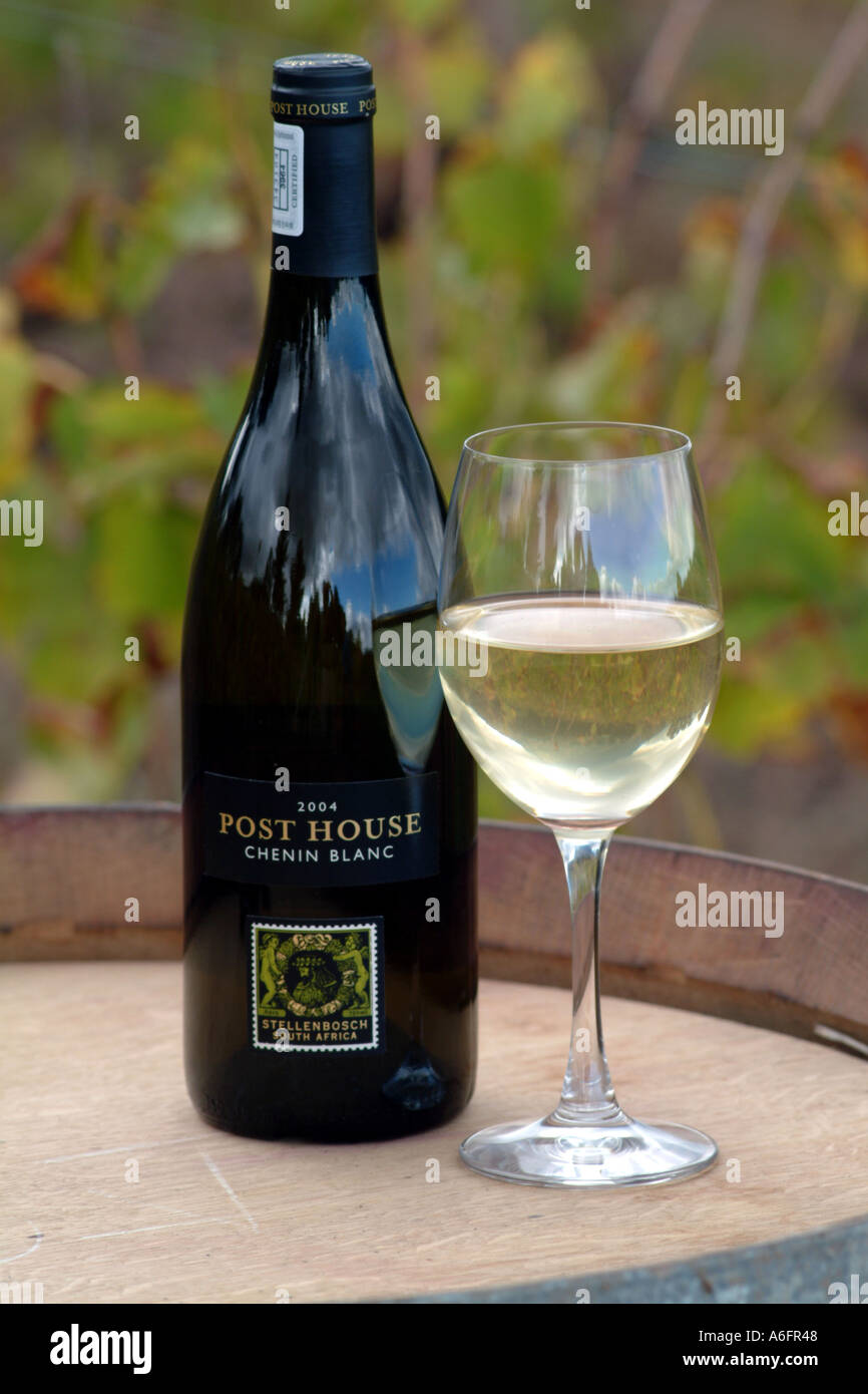 Bottle and glass of Chenin Blanc white wine on barrel Post House Wine