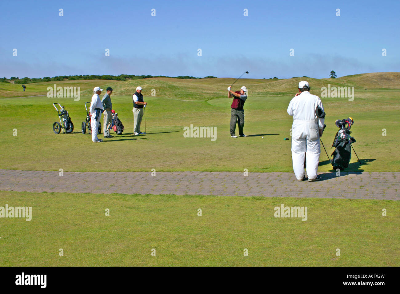 Golfers and caddies at Bandon Dunes Golf Resort Bandon Oregon Stock