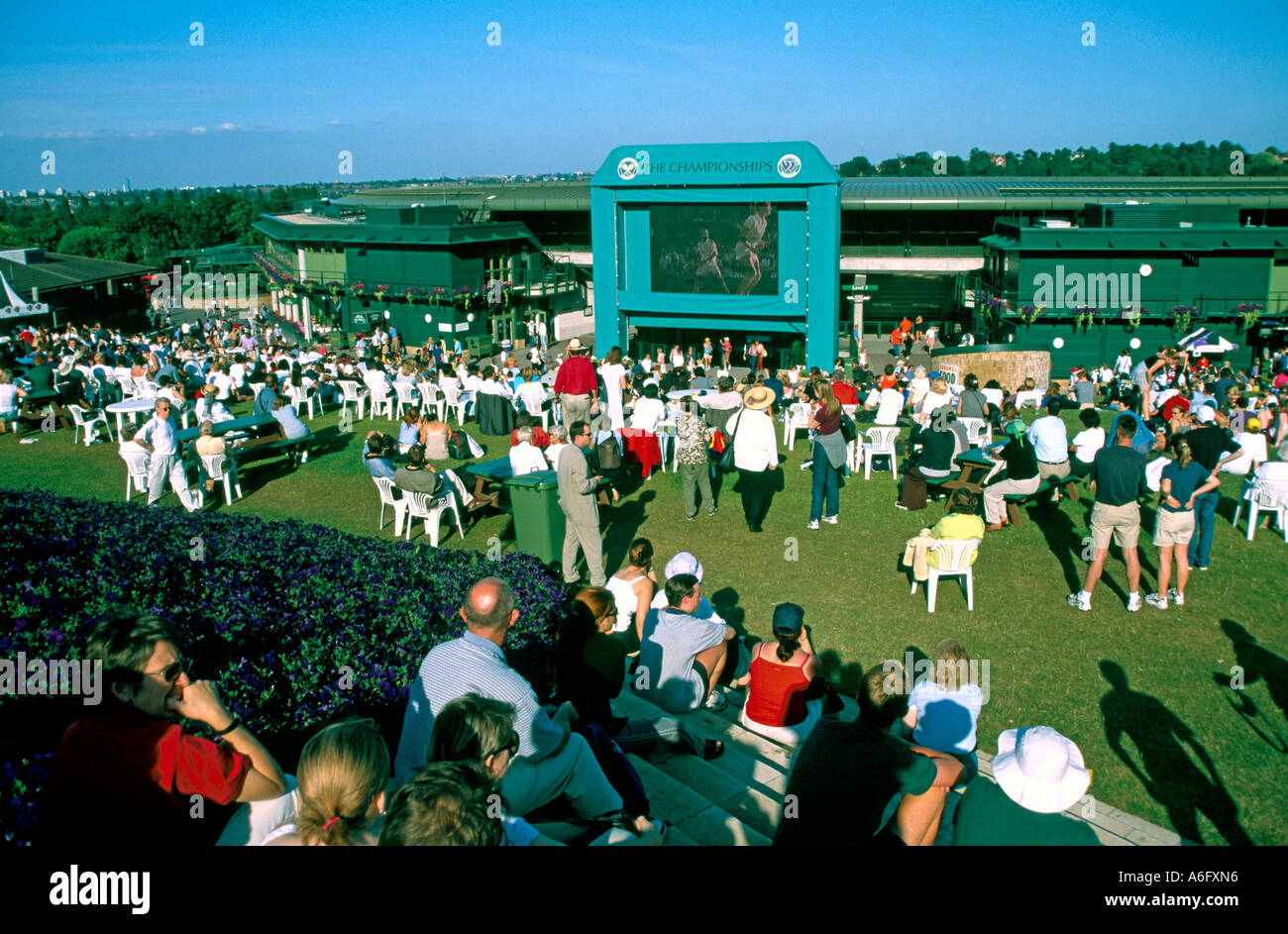 Spectators on Henman Hill watching live tennis on big television