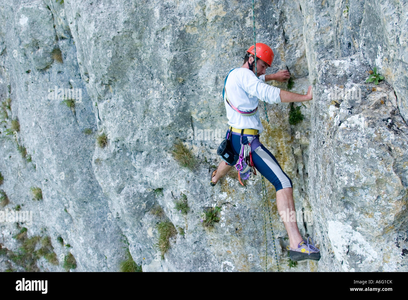 man around 35 years rock climbing in limestone Danube valley near Sigmaringen Swabian Jura Germany Stock Photo