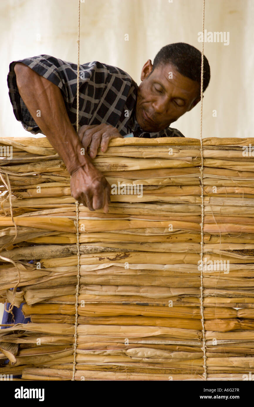 Joseph Séraphin Emile an artisan farmer from Cazal Haiti uses banana plant to create a mat Smithsonian Folklife Festival Stock Photo