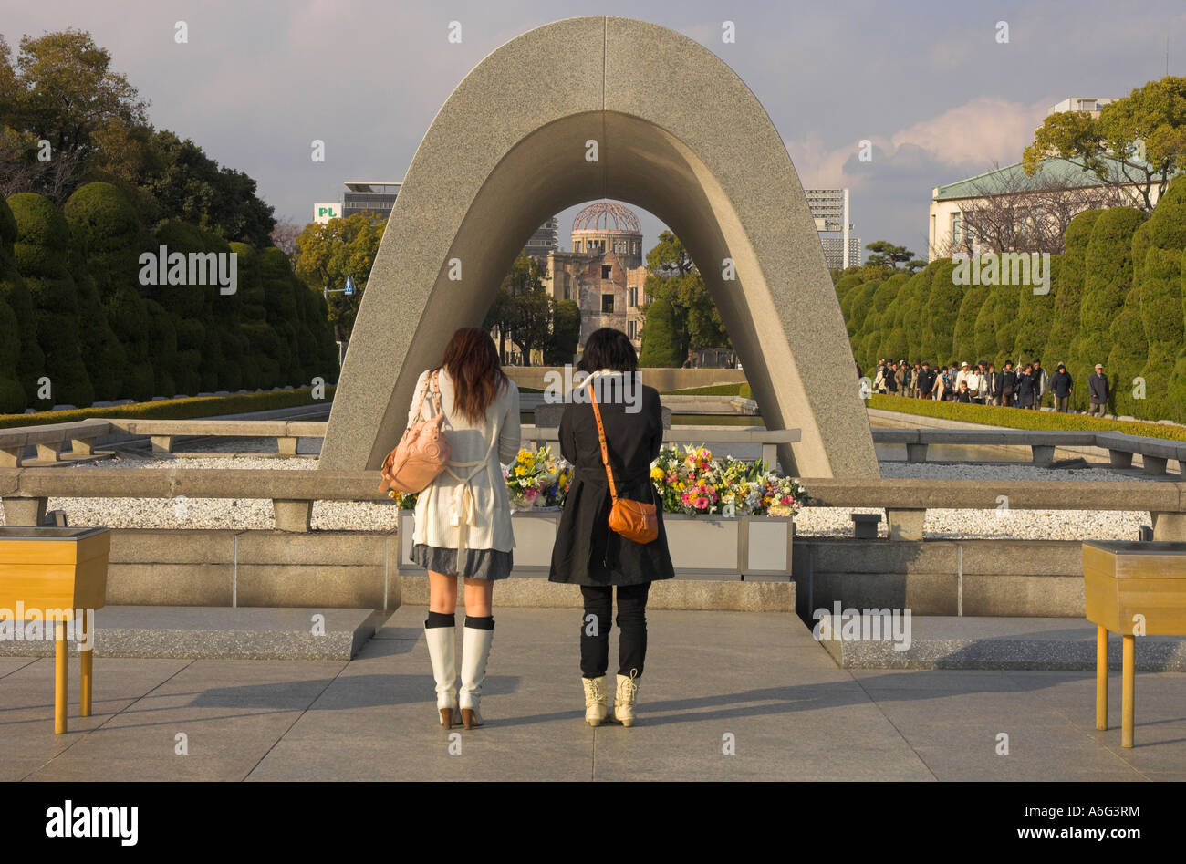 Japan Western Honshu Hiroshima Peace Memorial Park for atomic bomb of 6 august 1945 Cenotaph 2 young women standing in silent re Stock Photo