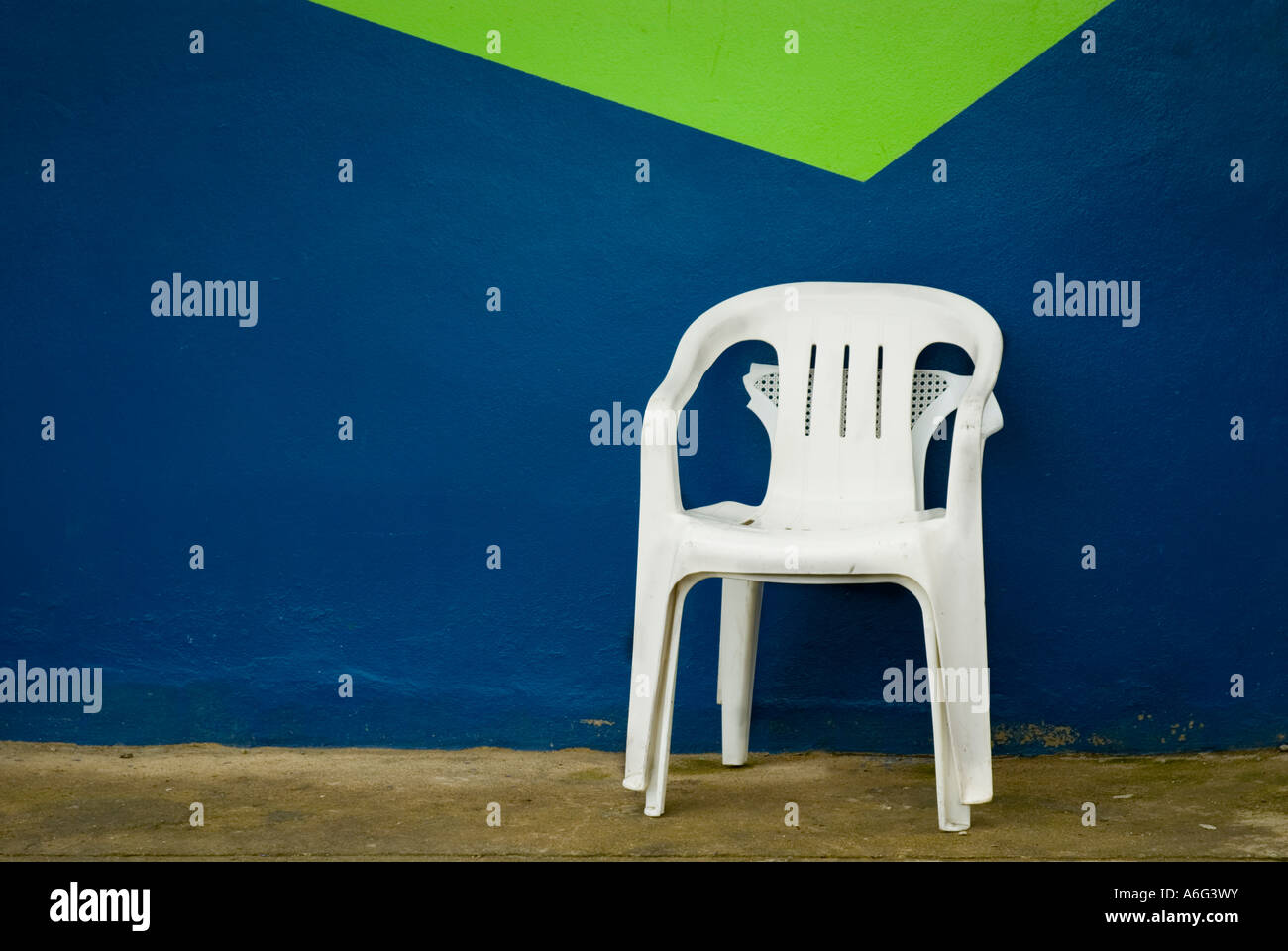 Chair against colorful wall, Town of Jarabacoa, Dominican Republic, 1/