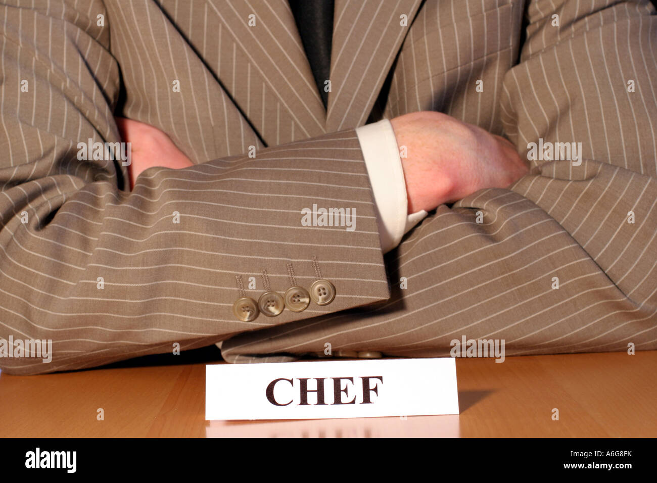 Man in suit with sign 'Chef' (Boss) Stock Photo